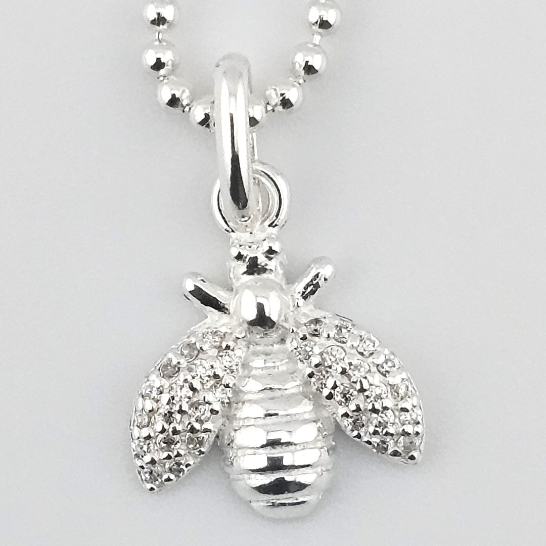 Bee charm pendant crafted in 925 sterling silver with CZ accents. 