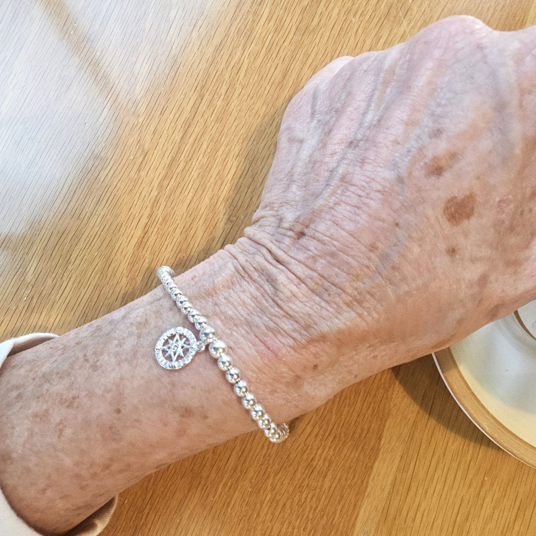 Sterling Silver Compass Bracelet on wrist.