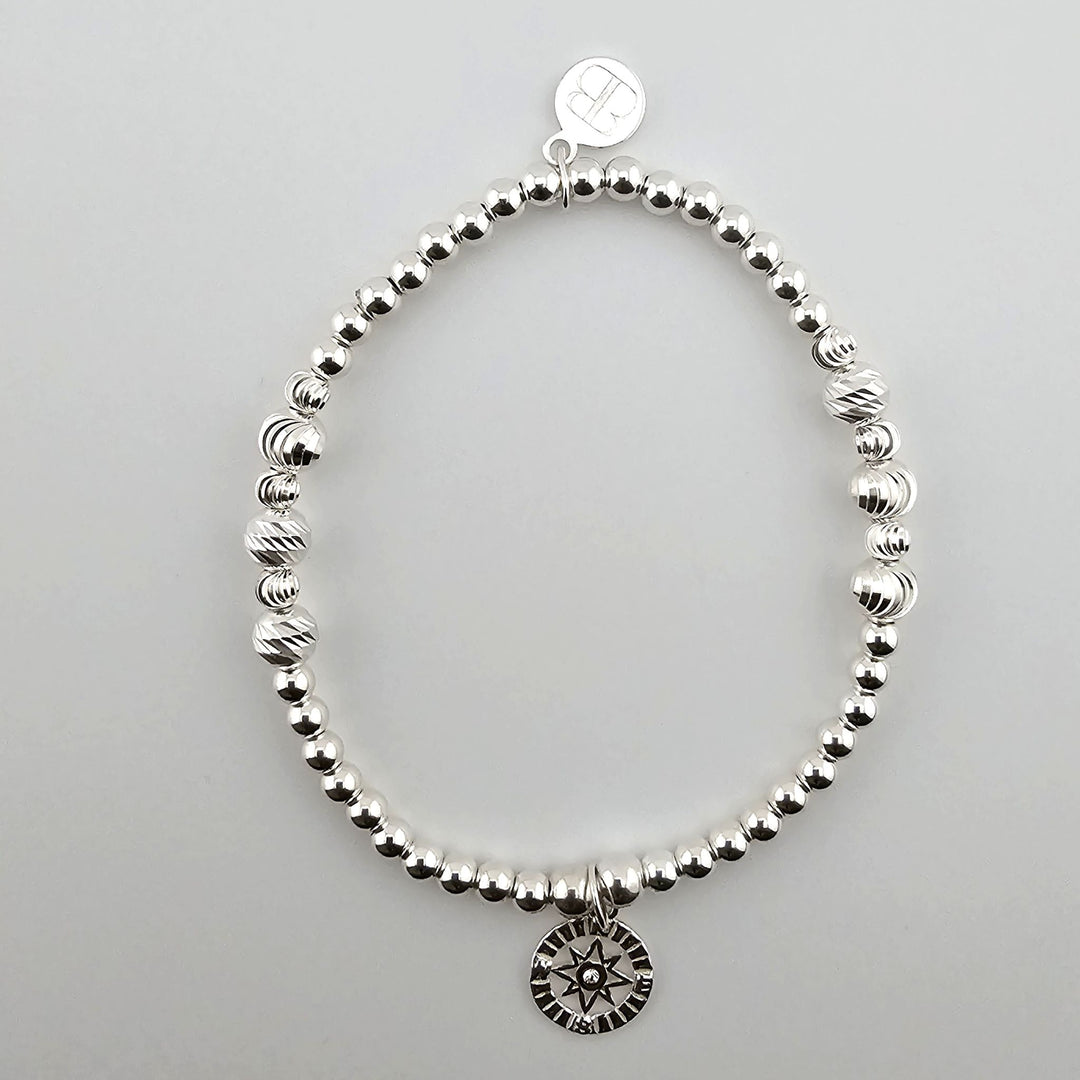 Sterling silver compass bracelet with beaded design.