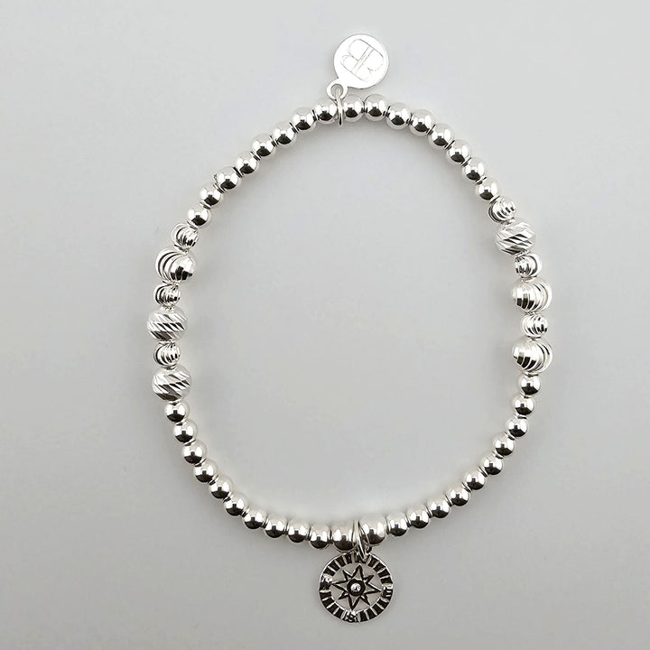 Sterling silver compass bracelet with beaded design.