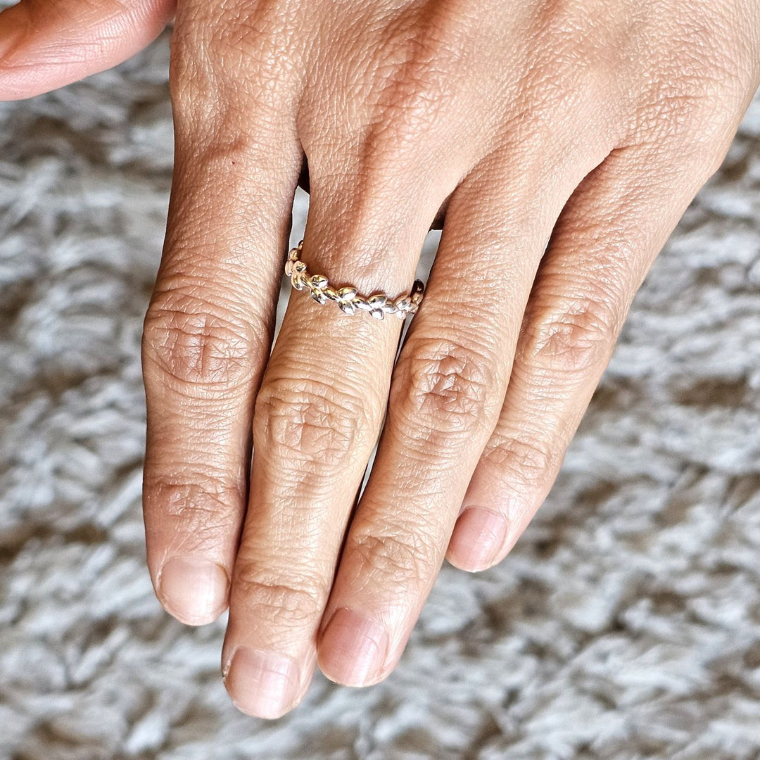 Sterling silver Crimson Leaves ring worn on a hand.