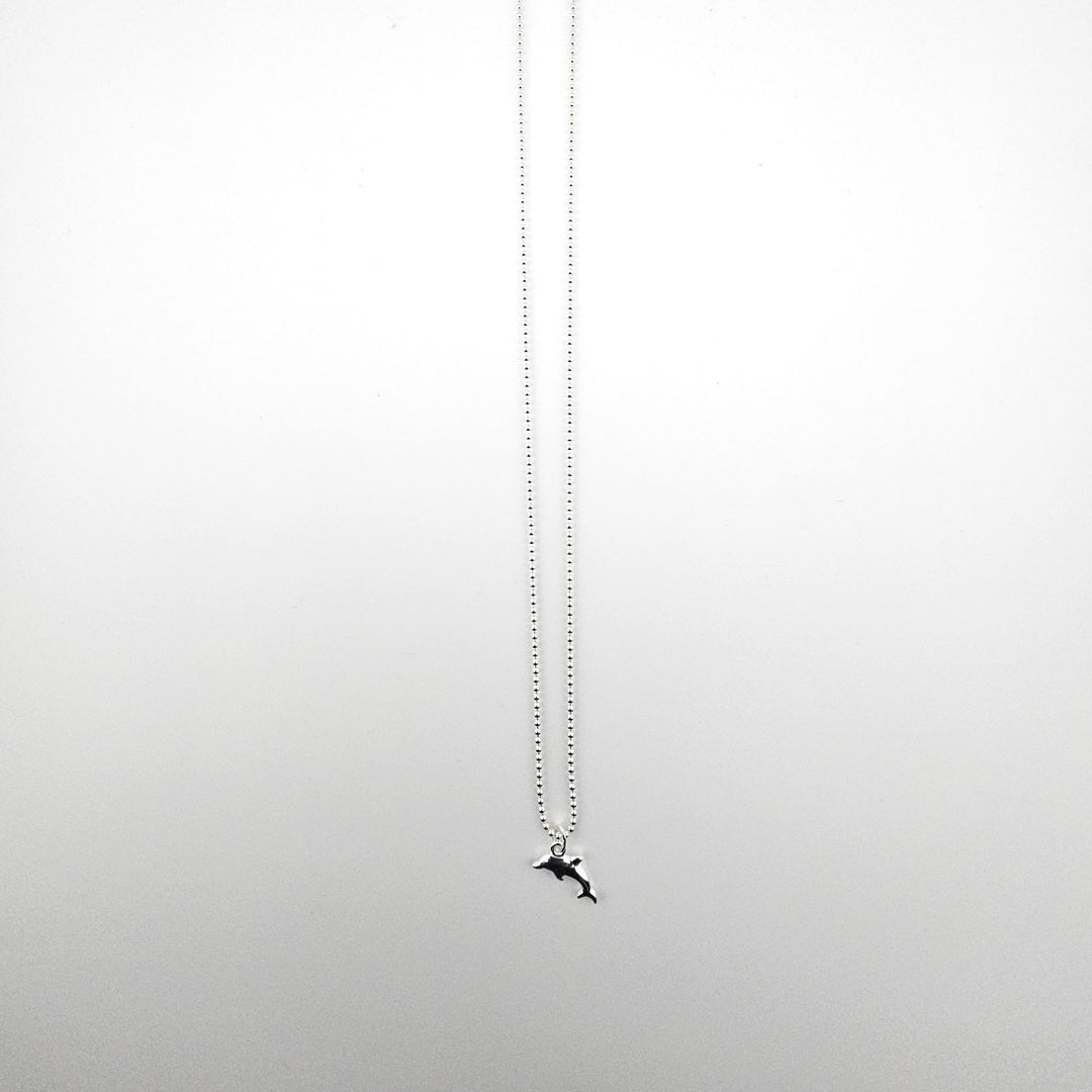 Sterling silver dolphin necklace by Bessie Bae on a fine silver chain.