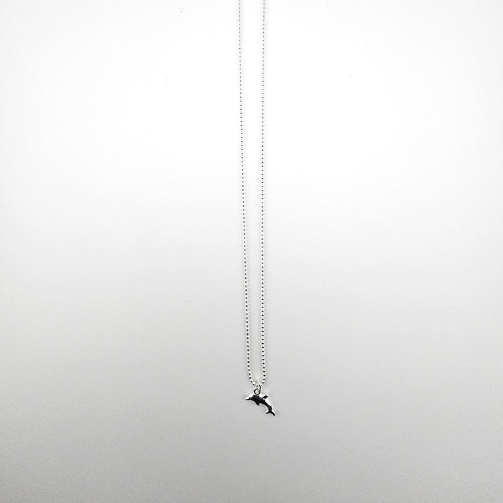 Sterling silver dolphin necklace by Bessie Bae on a fine silver chain.