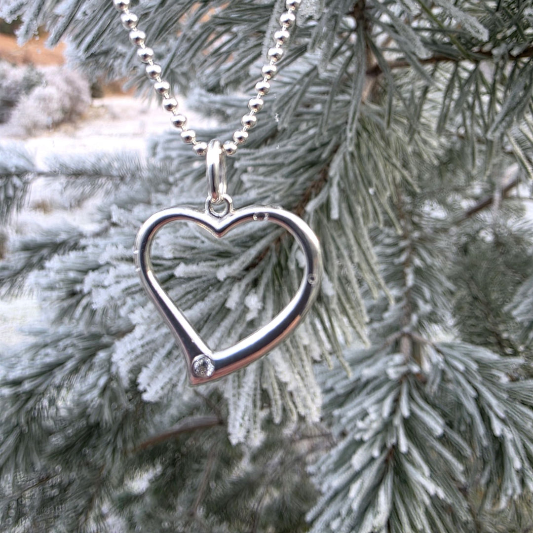 Sterling silver open heart necklace styled on frosted pine branches, winter jewellery gift inspiration by Bessie Bae.