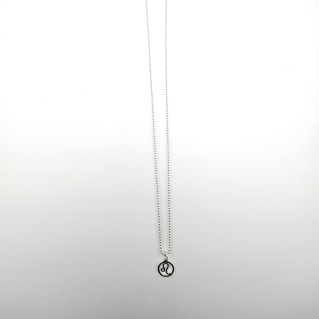 Sterling silver Leo zodiac necklace on a light background