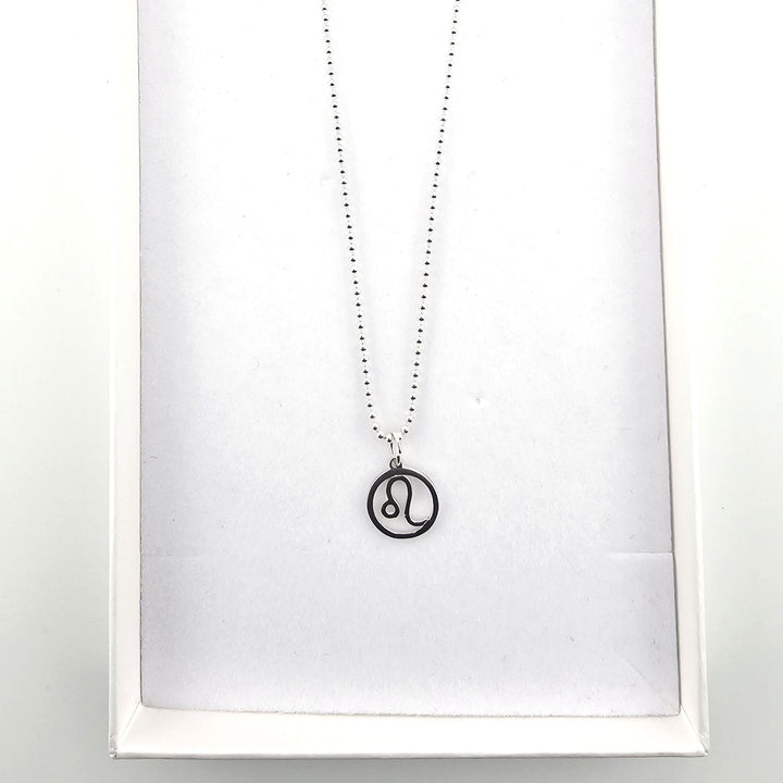 Sterling silver Leo zodiac necklace displayed inside a white jewellery gift box.