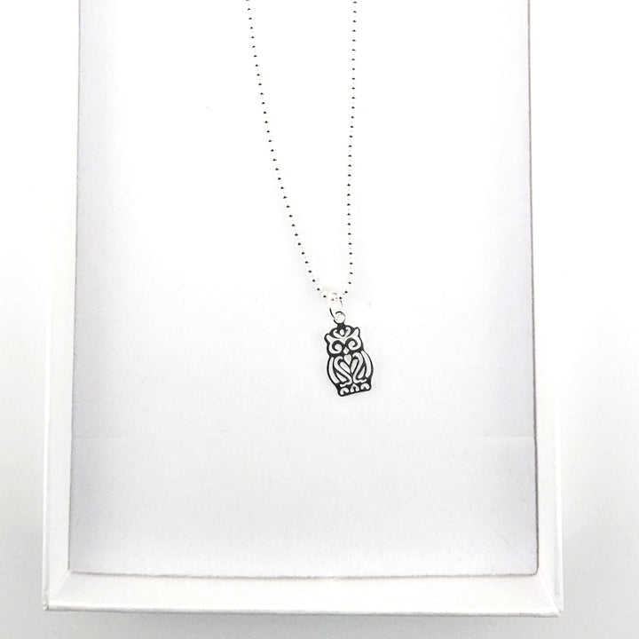Sterling silver owl necklace presented in a white gift box.
