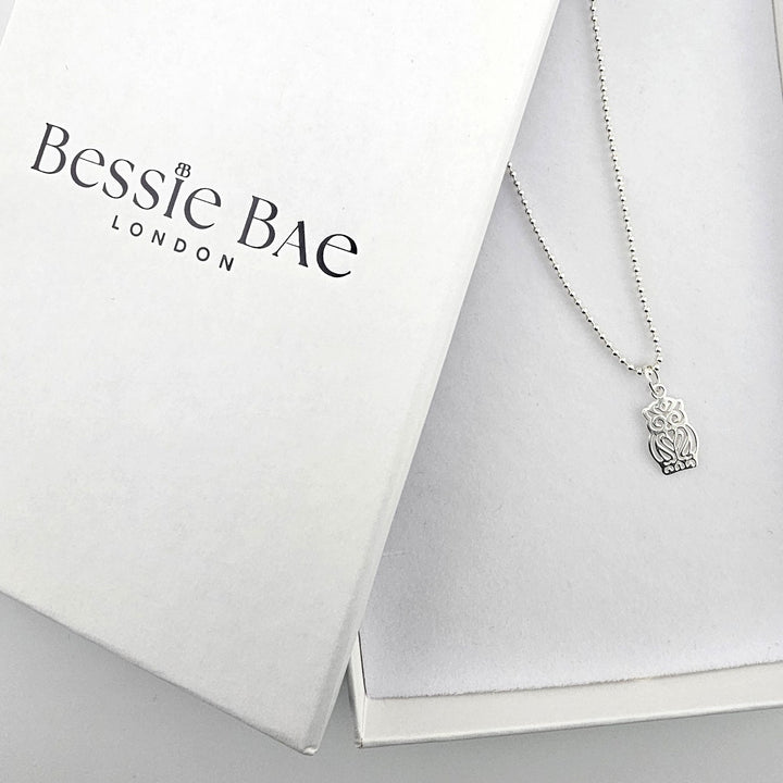 Sterling silver owl necklace displayed with Bessie Bae branded packaging.