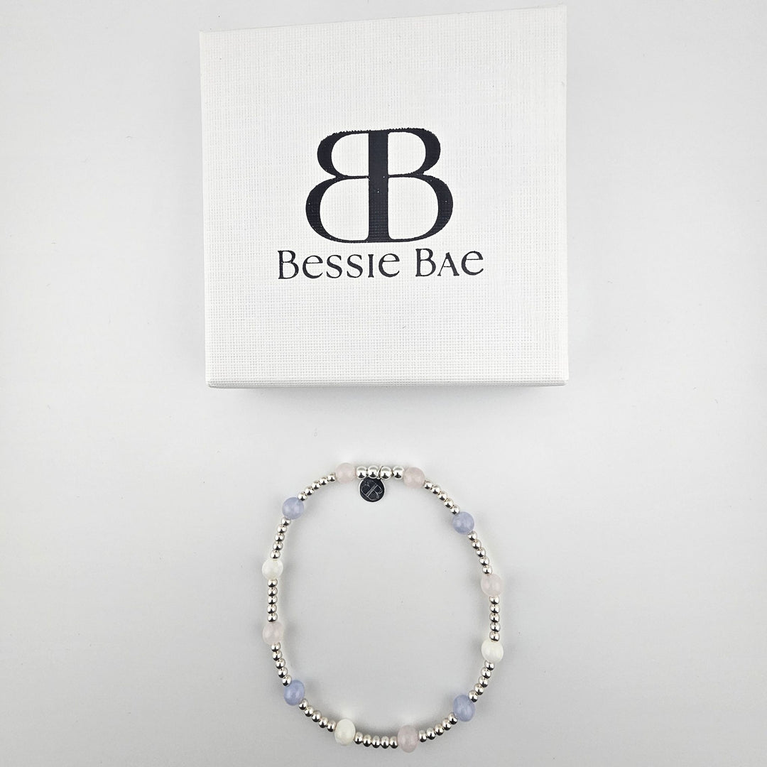 Sterling silver pastel gemstone anklet with branded packaging.