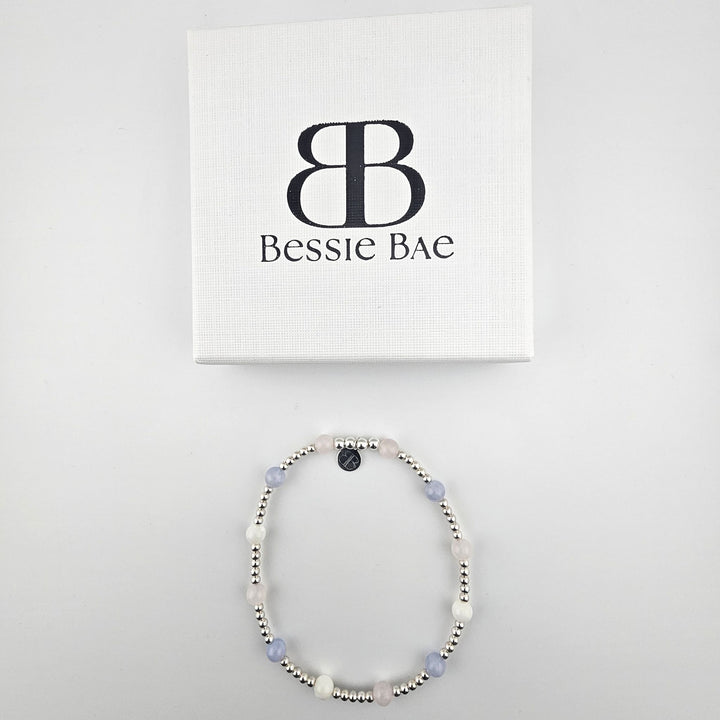 Sterling silver pastel gemstone anklet with branded packaging.