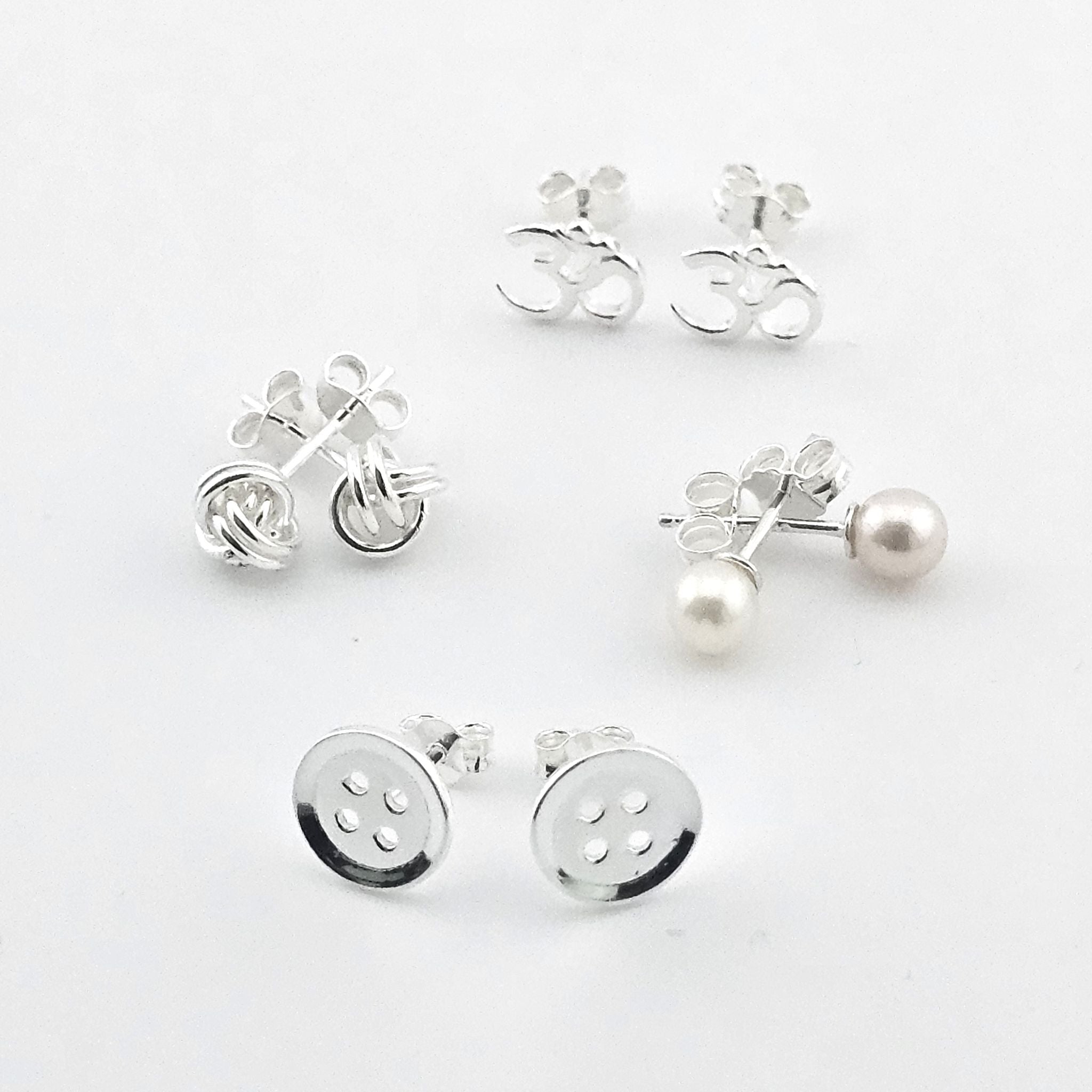 Bessie Bae sterling silver stud earrings set featuring pearl, knot, OM symbol and button designs.