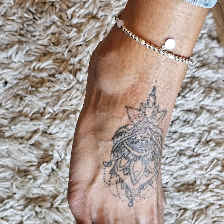 Sterling silver and Rose Quartz anklet worn on an ankle with a mandala tattoo.