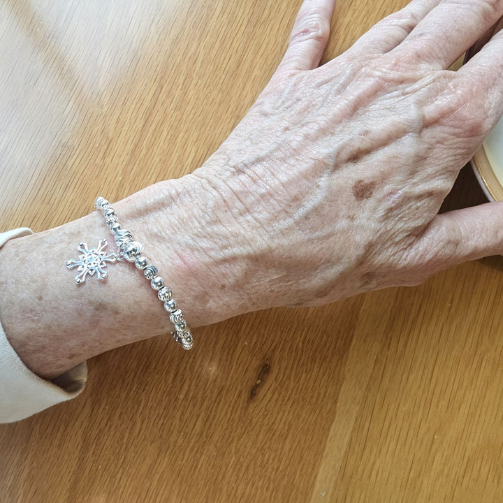 Sterling Silver Snowflake Bracelet by Bessie Bae on wrist.