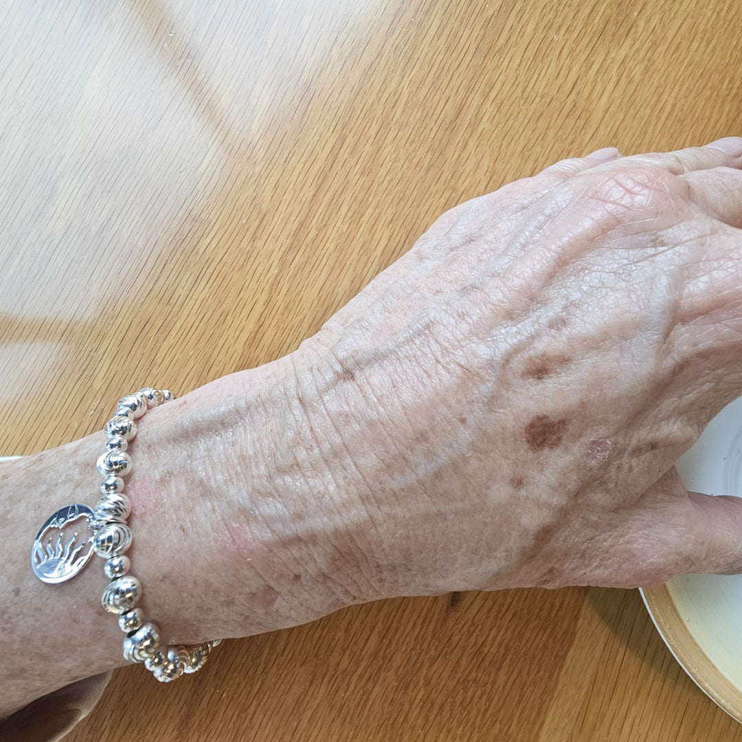 Sterling Silver Sun and Moon Bracelet by Bessie Bae on wrist.