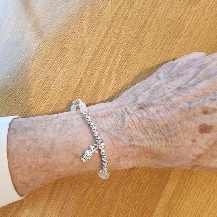 Sterling silver teddy bear bracelet with rose quartz and pearls.