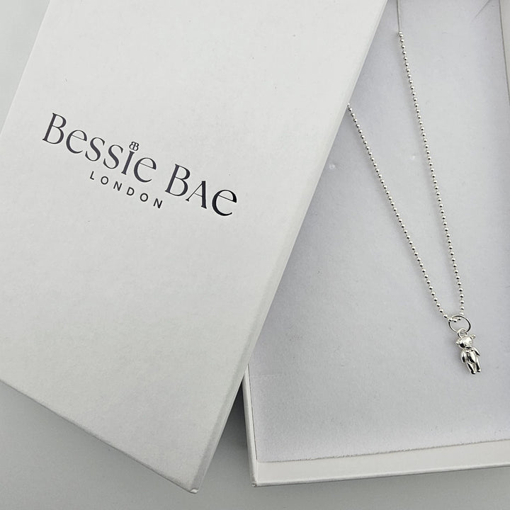 Sterling silver teddy bear necklace displayed in Bessie Bae London branded packaging.