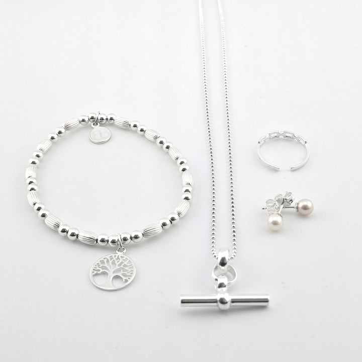 Bessie Bae sterling silver jewellery set featuring a tree of life bracelet, toggle necklace, pearl earrings and ring — handmade, elegant and gift-ready.