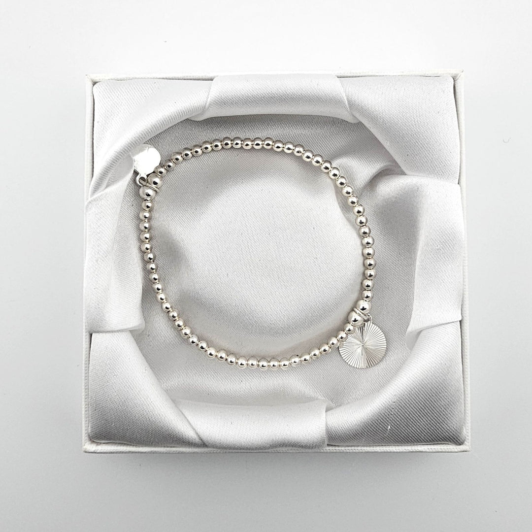Bessie Bae sunburst bracelet with packaging.