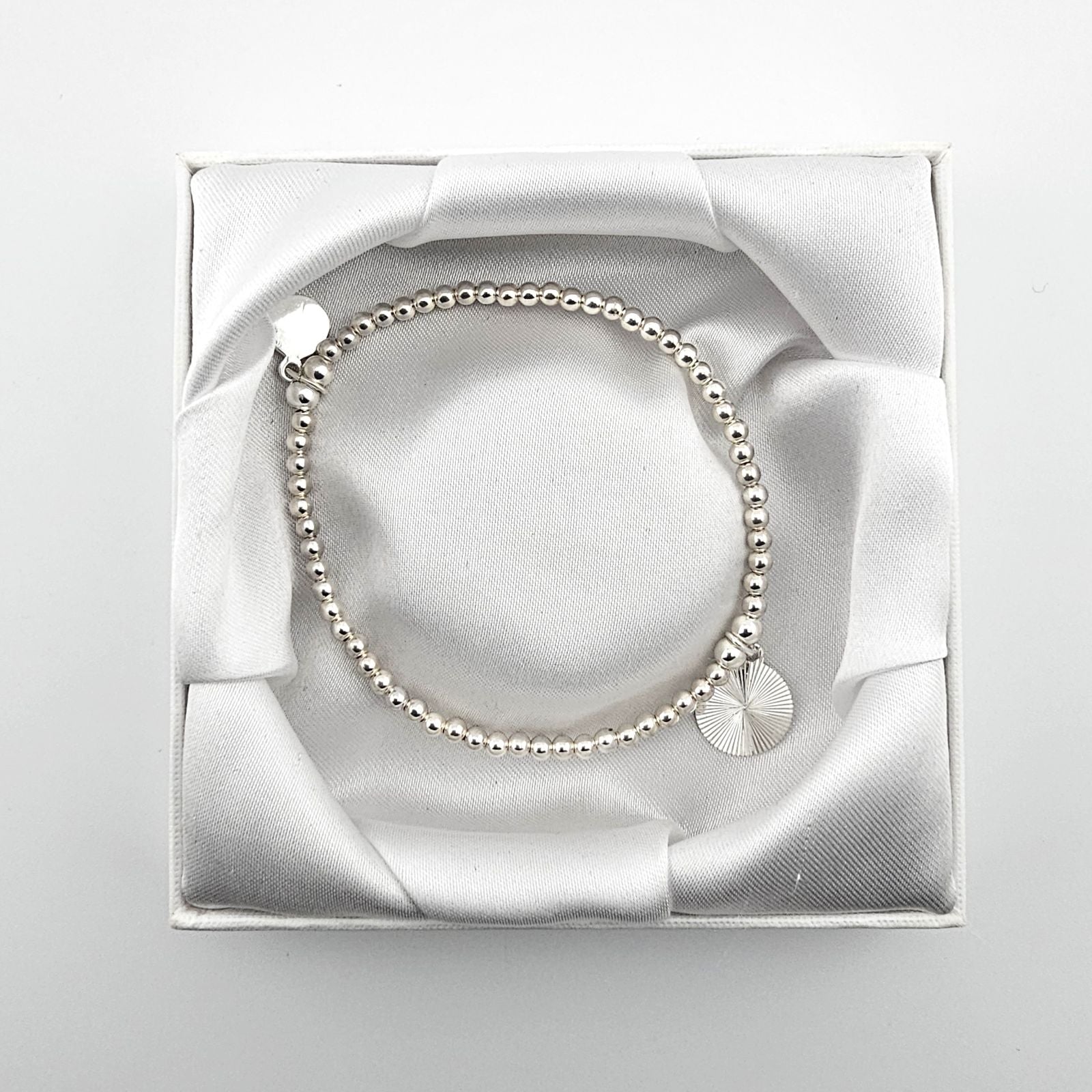Bessie Bae sunburst bracelet with packaging.