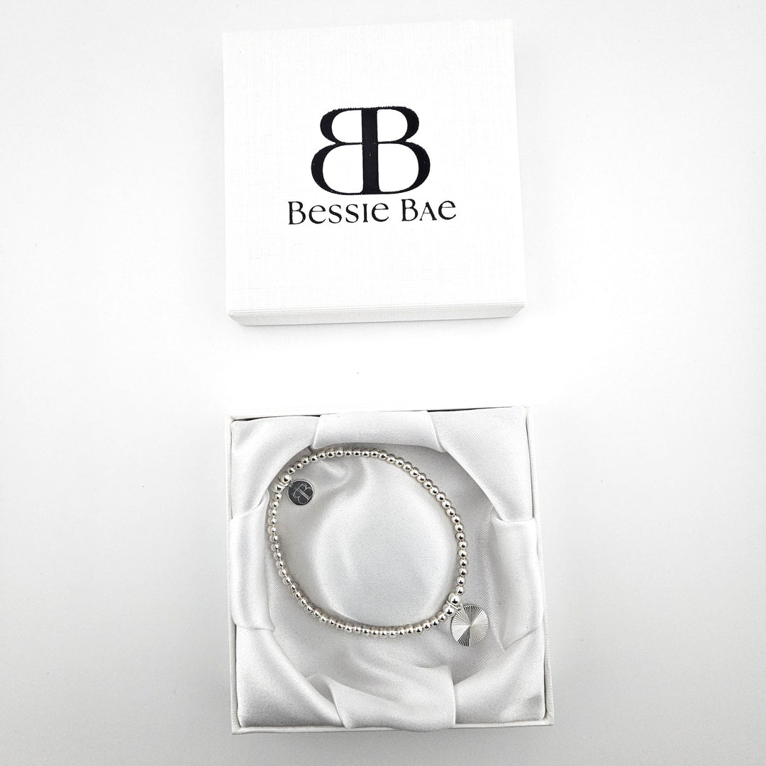 Sunburst charm sterling silver bracelet in white gift box.