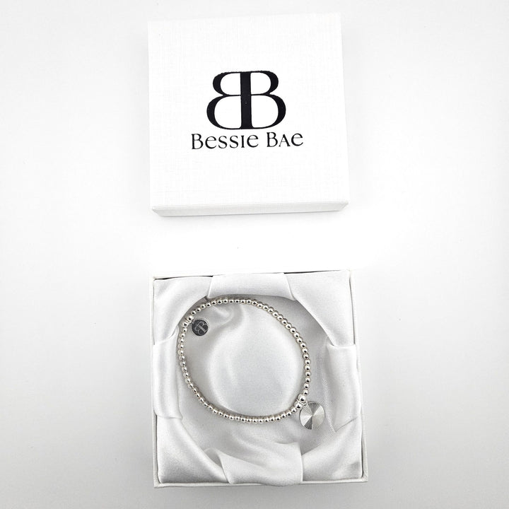 Sunburst charm sterling silver bracelet in white gift box.