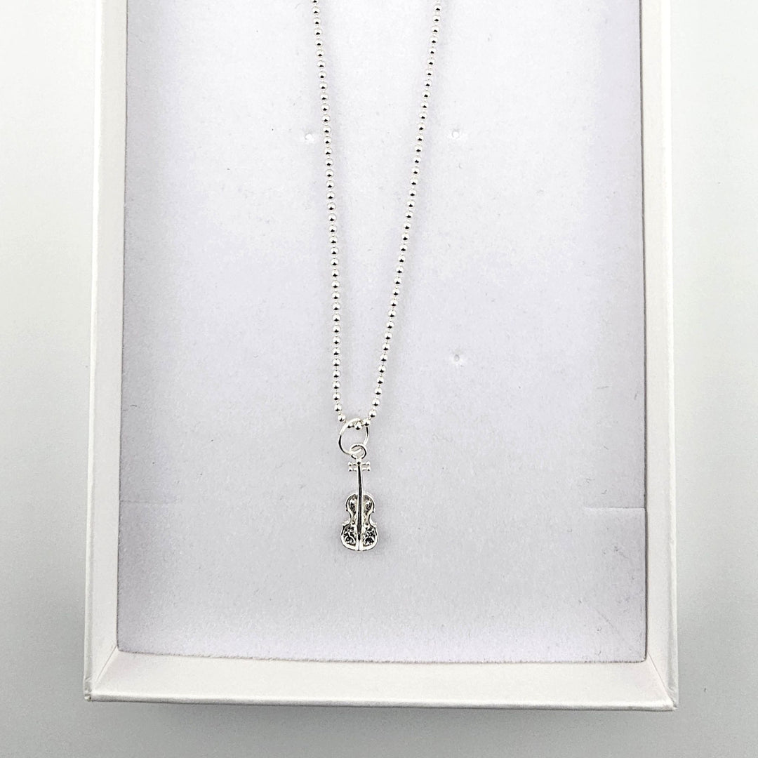 Sterling silver violin necklace presented in a Bessie Bae gift box.