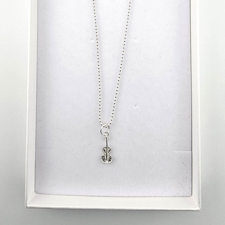 Sterling silver violin necklace presented in a Bessie Bae gift box.