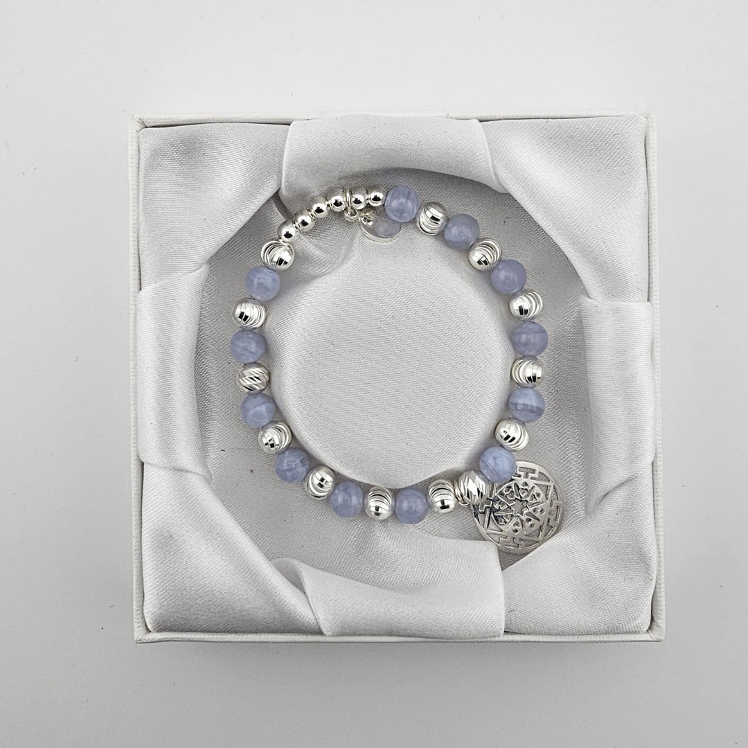 Top view of blue lace agate and silver Mandala bracelet in satin-lined box.