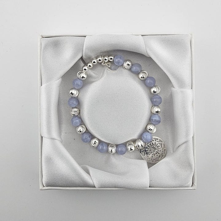 Top view of blue lace agate and silver Mandala bracelet in satin-lined box.