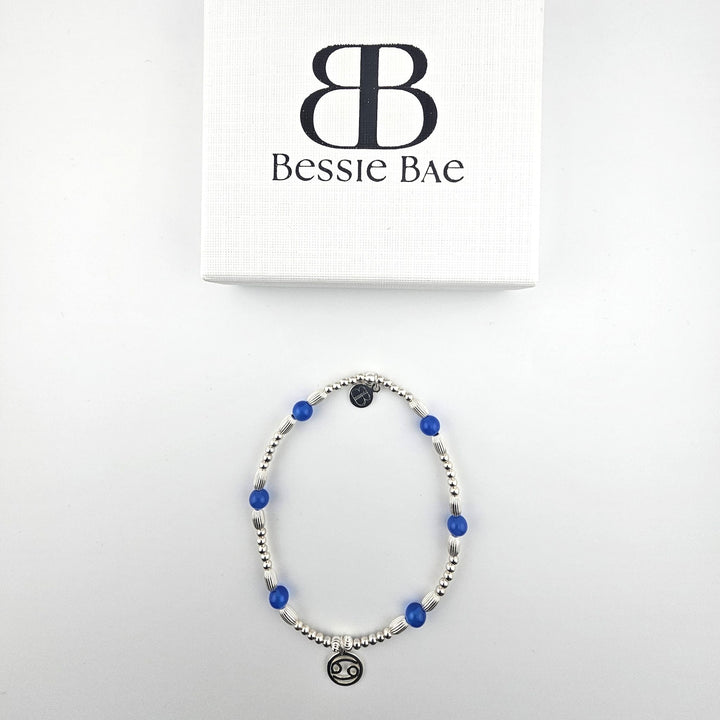Blue Agate Cancer anklet with sterling silver zodiac charm shown with Bessie Bae packaging.