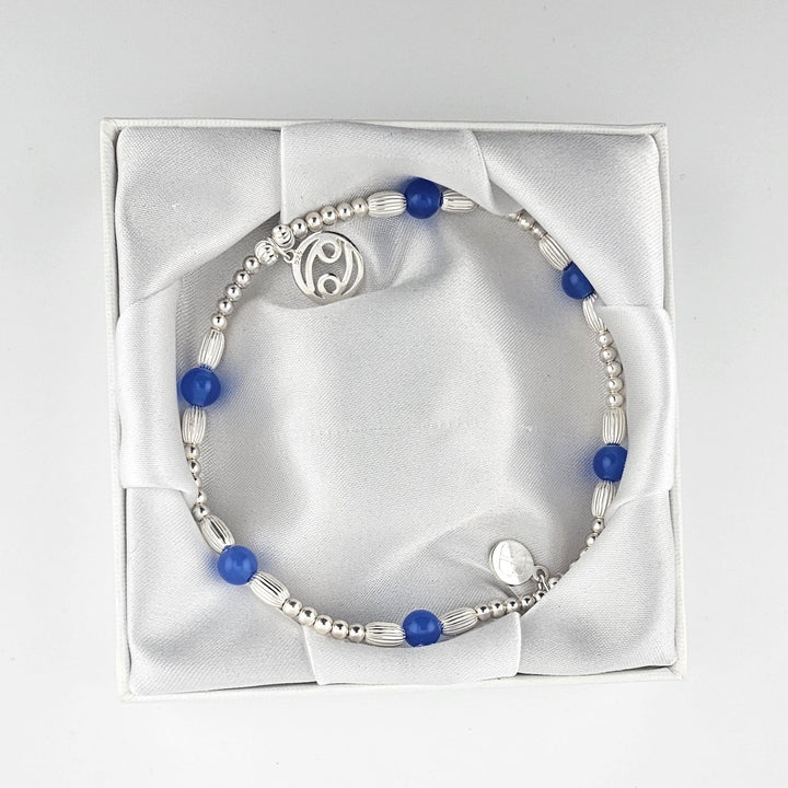 Cancer Blue Agate sterling silver anklet displayed in Bessie Bae gift box.