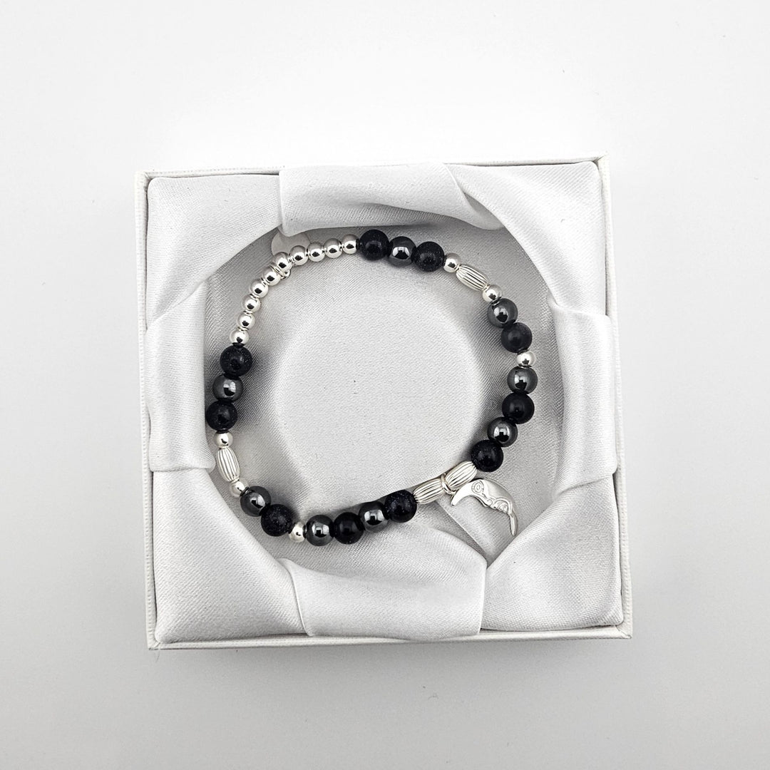 Bessie Bae packaging with Crescent Moon charm bracelet presented in white satin box.