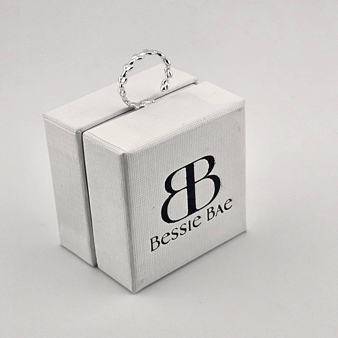 Sterling silver adjustable ring with leaf branch design.