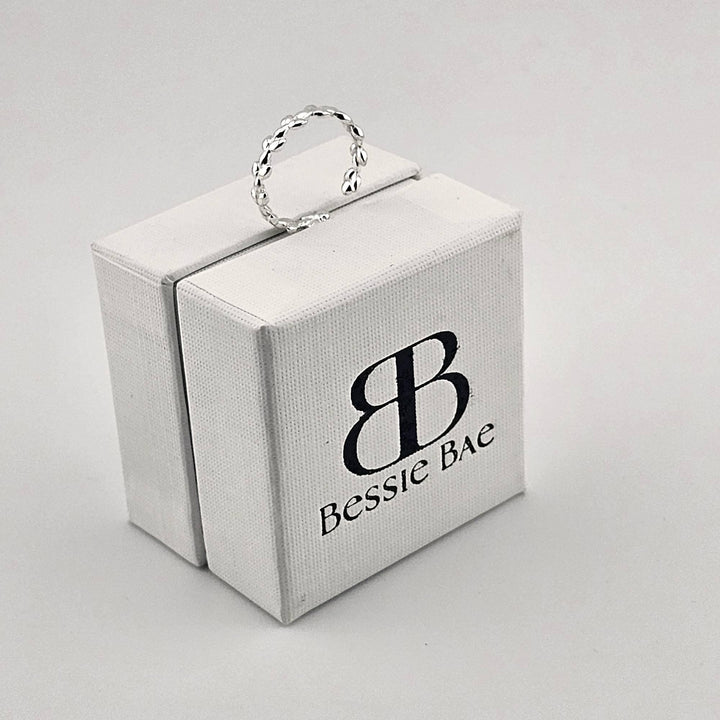 Sterling silver adjustable ring with leaf branch design.