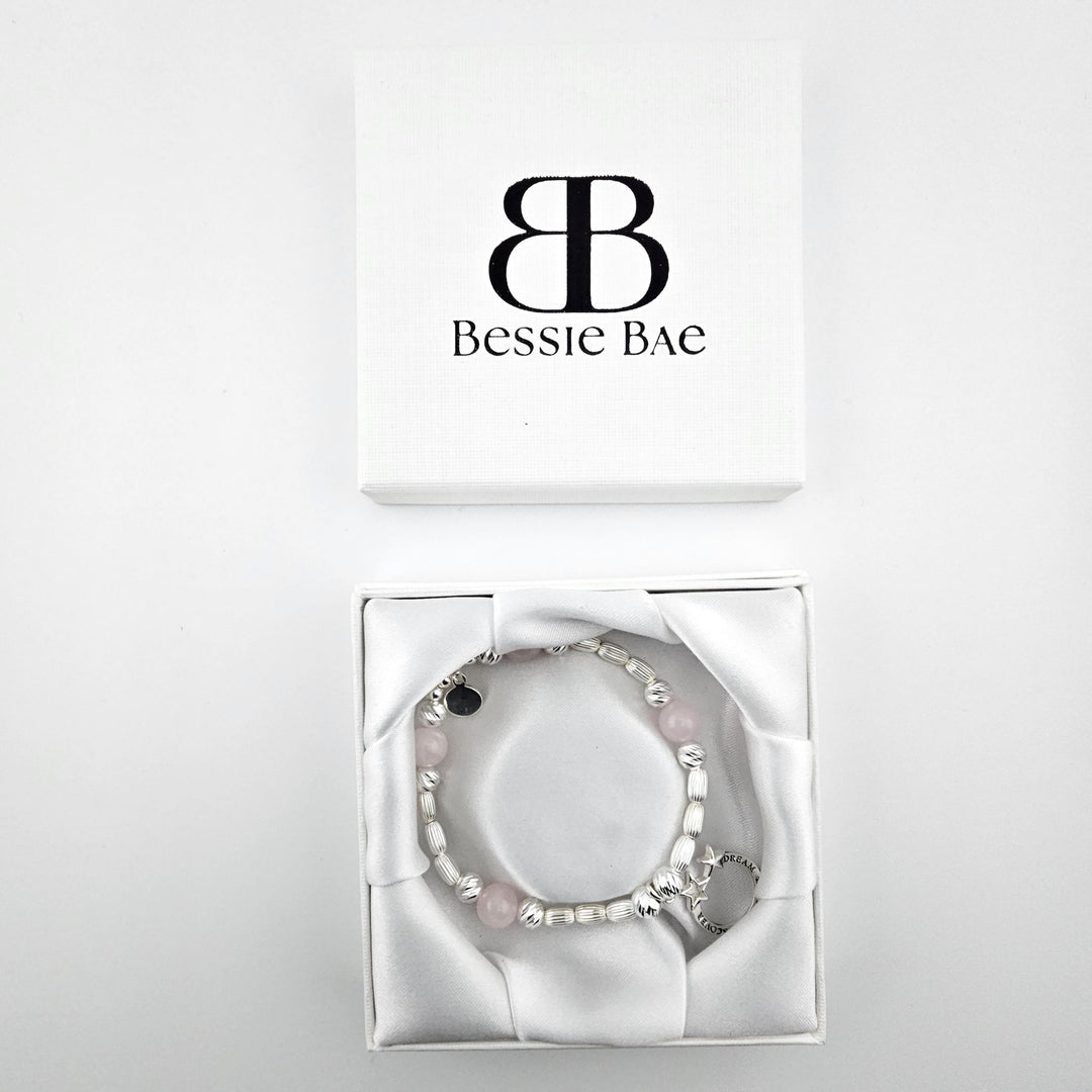 Sterling Silver Dream Explore Discover Bracelet with rose quartz gemstones displayed in Bessie Bae gift box.