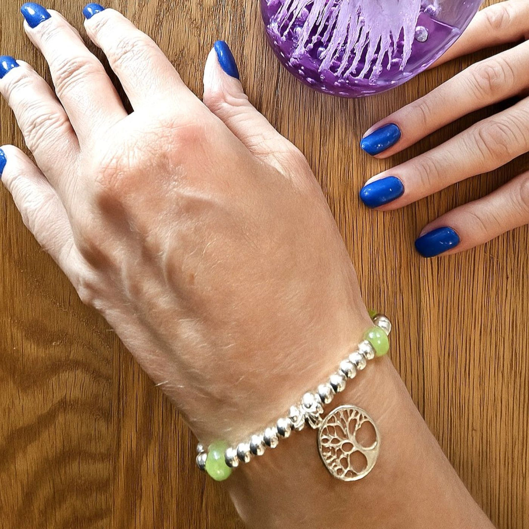 Green Aventurine and Sterling Silver Tree of Life Bracelet by Bessie Bae, shown on wrist with beaded design and silver charm.