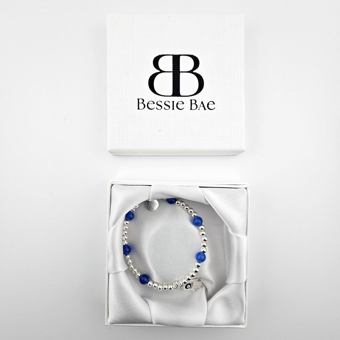 Sterling silver Hamsa hand bracelet with blue agate in Bessie Bae gift box.