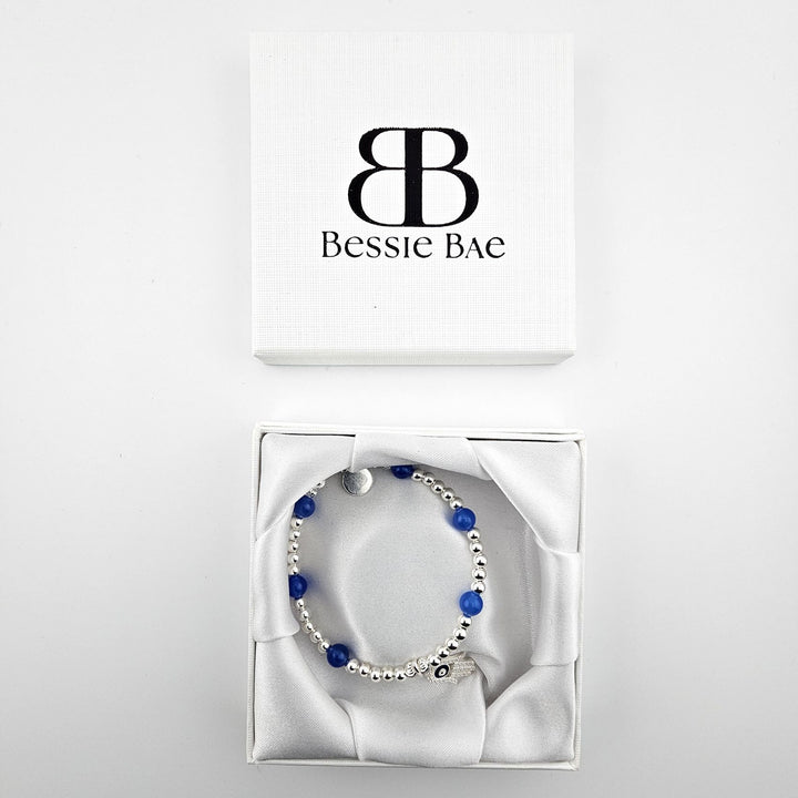 Sterling silver Hamsa hand bracelet with blue agate in Bessie Bae gift box.