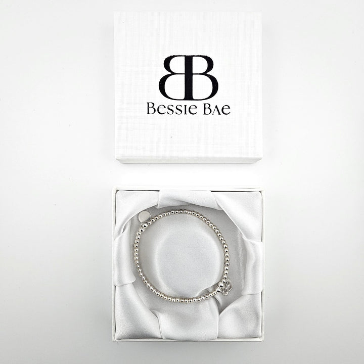 Interlocking hearts bracelet displayed in gift box.