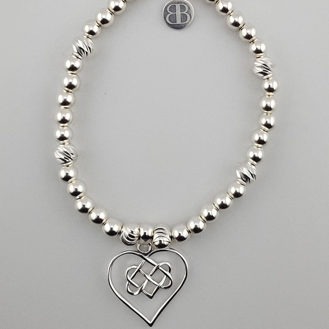 Sterling silver beaded bracelet with Celtic heart charm.