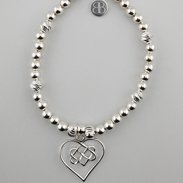 Sterling silver beaded bracelet with Celtic heart charm.
