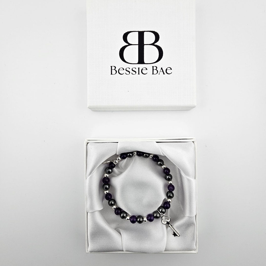 Amethyst and hematite beaded bracelet with silver key charm in Bessie Bae luxury gift box.
