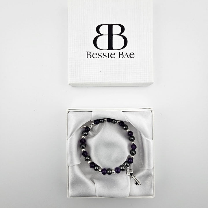 Amethyst and hematite beaded bracelet with silver key charm in Bessie Bae luxury gift box.