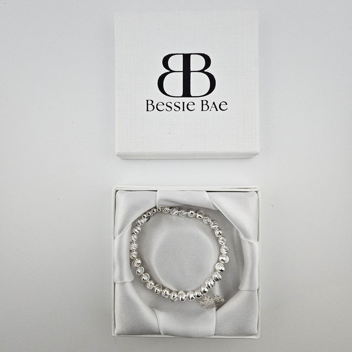 Sterling silver beaded snowflake charm bracelet in Bessie Bae gift box.