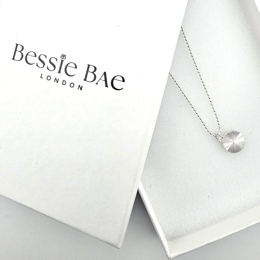 Starburst disc sterling silver necklace in Bessie Bae branded gift packaging.