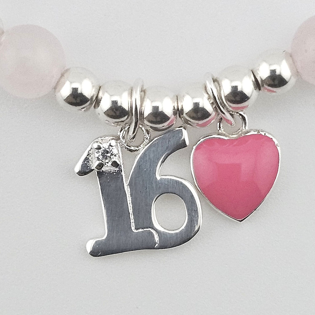 Close-up of Sterling Silver number 16 charm with pink enamel heart accent.