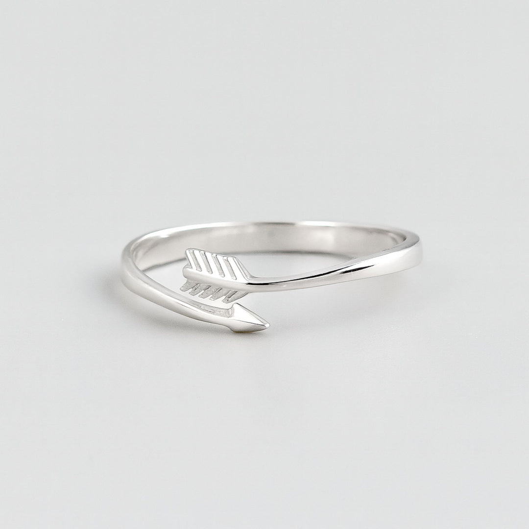 Sterling silver 20mm arrow adjustable ring on grey background.