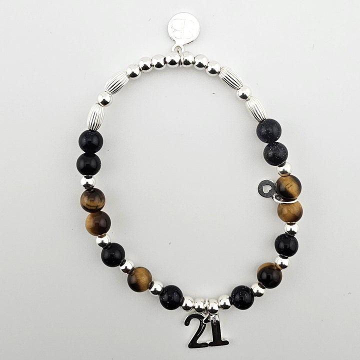 Sterling Silver 21 Bracelet with Tiger’s Eye and Goldstone beads by Bessie Bae, shown flat on light background.