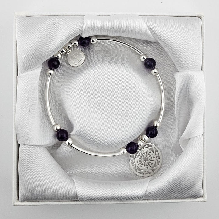 Amethyst gemstone bracelet with silver mandala pendant.