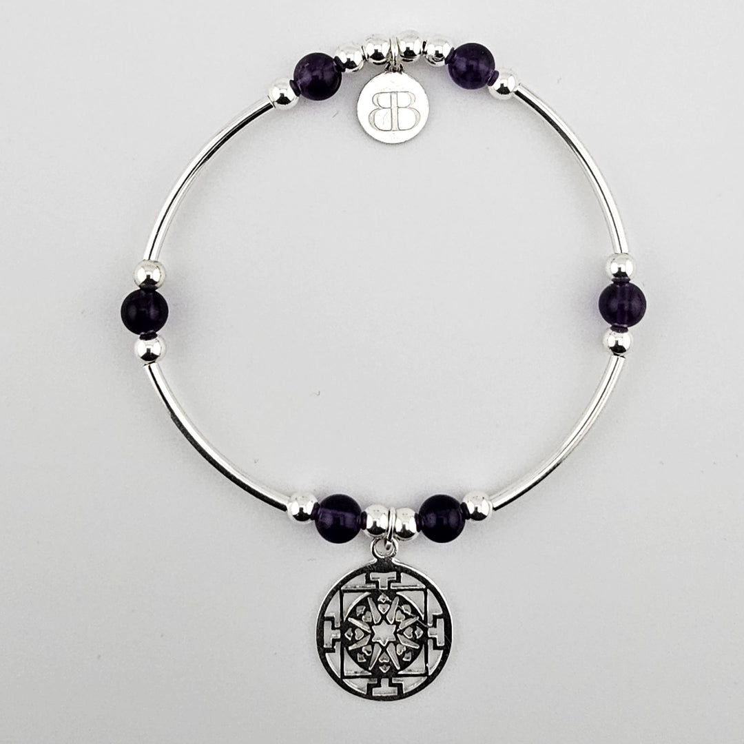 Sterling silver bracelet with amethyst beads and mandala charm.